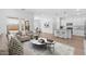 Open-concept living area, seamlessly connecting the living room, dining area, and modern kitchen at 23385 W Burton Ave, Buckeye, AZ 85326