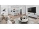 Open-concept living room that has stylish furnishings, decor, and seamlessly connects to the kitchen at 23385 W Burton Ave, Buckeye, AZ 85326