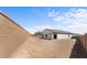 Expansive backyard ready for landscaping, featuring block wall for privacy, and patio access at 23456 W Fulton St, Buckeye, AZ 85326