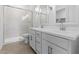 The bathroom features double sinks with a large, tiled walk-in shower behind a glass door at 23456 W Fulton St, Buckeye, AZ 85326