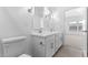 Well lit bathroom features a double sink vanity, sleek fixtures, and an adjacent bedroom at 23456 W Fulton St, Buckeye, AZ 85326