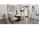 Contemporary dining area with an elegant table set for six and a sliding glass door to the patio at 23456 W Fulton St, Buckeye, AZ 85326