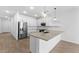 Modern kitchen featuring stainless steel appliances, a central island, and stylish pendant lighting at 23456 W Fulton St, Buckeye, AZ 85326
