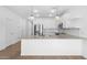 Well-lit kitchen boasts an eat-in island, stainless steel appliances, and open-concept design at 23456 W Fulton St, Buckeye, AZ 85326