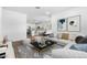 Bright, open-concept living room with modern decor and a view into the kitchen at 23456 W Fulton St, Buckeye, AZ 85326