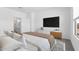 Stylish main bedroom features a modern TV console and ensuite bathroom with walk-in shower at 23456 W Fulton St, Buckeye, AZ 85326