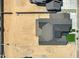Aerial view showcasing a home's roof, landscaping, and surrounding bare land in a new development at 26619 S 169Th Pl, Queen Creek, AZ 85142