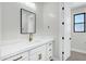 Elegant bathroom features marble countertops, brass hardware, and a sleek mirror and lighting fixture at 26619 S 169Th Pl, Queen Creek, AZ 85142