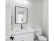 Modern half-bath features a square mirror, white vanity, and sleek fixtures adding elegance to the space at 26619 S 169Th Pl, Queen Creek, AZ 85142