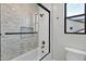 Contemporary bathroom featuring a tiled shower with a glass door, a window, and bronze fixtures at 26619 S 169Th Pl, Queen Creek, AZ 85142