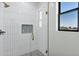 Modern bathroom boasts subway-tiled shower, glass enclosure, and black framed window with neighborhood views at 26619 S 169Th Pl, Queen Creek, AZ 85142