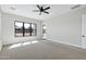 Open bedroom featuring neutral carpet, a ceiling fan, and natural light at 26619 S 169Th Pl, Queen Creek, AZ 85142