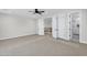 Spacious bedroom leading to stairs and bathroom, showcasing neutral walls, carpet, and natural light at 26619 S 169Th Pl, Queen Creek, AZ 85142