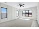 Spacious bedroom featuring bright white walls, a modern ceiling fan, and large windows at 26619 S 169Th Pl, Queen Creek, AZ 85142