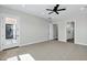 Bright bedroom with door leading to bathroom and glass door leading outside at 26619 S 169Th Pl, Queen Creek, AZ 85142