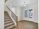 Spacious foyer showcasing a staircase, light fixture, and white French doors, with beautiful hardwood flooring at 26619 S 169Th Pl, Queen Creek, AZ 85142
