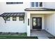 Charming home entrance featuring double doors, white brick, manicured landscaping, and the house number at 26619 S 169Th Pl, Queen Creek, AZ 85142