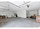 Spacious garage with an epoxy floor, water heater, and garage door with opener at 26619 S 169Th Pl, Queen Creek, AZ 85142