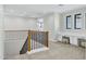 Spacious hallway boasts natural light, a study nook with built-ins, and stylish wood-and-metal staircase at 26619 S 169Th Pl, Queen Creek, AZ 85142