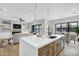 Bright open kitchen with modern white countertops, wooden cabinets, and stainless steel appliances at 26619 S 169Th Pl, Queen Creek, AZ 85142