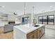 Open concept kitchen includes a large island, modern lighting, and stainless appliances at 26619 S 169Th Pl, Queen Creek, AZ 85142