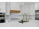 Chef's kitchen showcases an island with a sink, gold hardware, and custom cabinets at 26619 S 169Th Pl, Queen Creek, AZ 85142