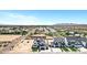 View of a residential street featuring modern homes with black and white exteriors and desert landscaping at 26619 S 169Th Pl, Queen Creek, AZ 85142