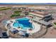 An aerial view of a community center with swimming pool, lounge areas, and surrounding desert landscape at 27021 W Kerry Ln, Buckeye, AZ 85396