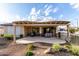 Beautiful covered patio with outdoor kitchen, dining and seating area overlooks the landscaped backyard at 27021 W Kerry Ln, Buckeye, AZ 85396