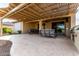 Spacious covered patio with outdoor kitchen, dining and lounge area for outdoor entertaining at 27021 W Kerry Ln, Buckeye, AZ 85396