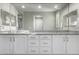 Bathroom vanity with double sinks, granite countertop and white cabinets at 27021 W Kerry Ln, Buckeye, AZ 85396