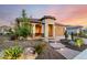 Lovely home with xeriscaping, a clay tile roof, and well manicured plants at 27021 W Kerry Ln, Buckeye, AZ 85396