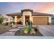 Charming home featuring desert landscaping, a clay tile roof, and a welcoming entrance at 27021 W Kerry Ln, Buckeye, AZ 85396