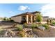 Attractive home with desert landscaping and covered front porch at 27021 W Kerry Ln, Buckeye, AZ 85396