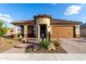 Inviting residence with a well-maintained front yard showcasing desert flora and paved driveway at 27021 W Kerry Ln, Buckeye, AZ 85396