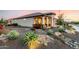 Home exterior with desert landscaping and a covered front porch at 27021 W Kerry Ln, Buckeye, AZ 85396