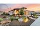 Beautiful desert landscaping surrounds this lovely home with views of the sunset sky at 27021 W Kerry Ln, Buckeye, AZ 85396