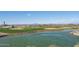 Picturesque golf course with a tranquil pond and mountain views at 27021 W Kerry Ln, Buckeye, AZ 85396