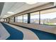 Hallway with blue and white patterned floor and expansive windows overlooking a golf course and mountain views at 27021 W Kerry Ln, Buckeye, AZ 85396