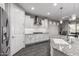 Bright, modern kitchen features white cabinets, granite countertops, and stainless steel appliances at 27021 W Kerry Ln, Buckeye, AZ 85396