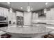 Spacious kitchen with a large island, granite countertops, and modern pendant lighting at 27021 W Kerry Ln, Buckeye, AZ 85396