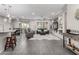 Open-concept living room with gray tile floors, recessed lighting, and comfortable seating at 27021 W Kerry Ln, Buckeye, AZ 85396