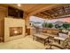 Spacious outdoor living area with fireplace, TV, comfortable seating and BBQ at 27021 W Kerry Ln, Buckeye, AZ 85396