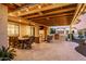 Inviting outdoor living space with a covered patio, fireplace, dining area, and built-in grill at 27021 W Kerry Ln, Buckeye, AZ 85396