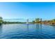 Scenic pond with a central fountain surrounded by lush greenery and community homes at 27021 W Kerry Ln, Buckeye, AZ 85396