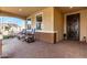 Inviting covered patio with a decorative security door and a brick paver floor at 27021 W Kerry Ln, Buckeye, AZ 85396