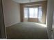 Spacious bedroom with a bay window, carpeted floors, and neutral-colored walls at 29797 W Mitchell Ave, Buckeye, AZ 85396
