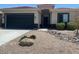 Single-story home featuring a two-car garage, desert landscaping, and a neutral color scheme at 29797 W Mitchell Ave, Buckeye, AZ 85396