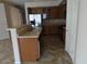 Open kitchen featuring wood cabinetry, stainless steel appliances, and a breakfast bar at 29797 W Mitchell Ave, Buckeye, AZ 85396
