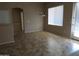Open living space with tile flooring, neutral walls, and natural light from large windows at 29797 W Mitchell Ave, Buckeye, AZ 85396